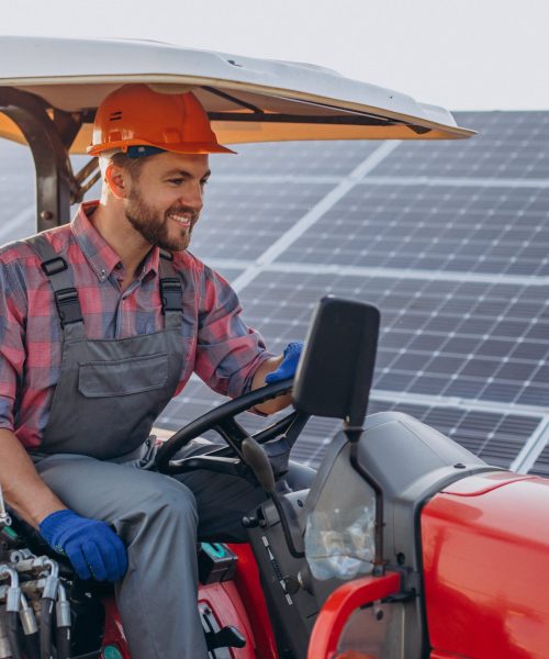 man-truck-driving-by-solar-panels-min